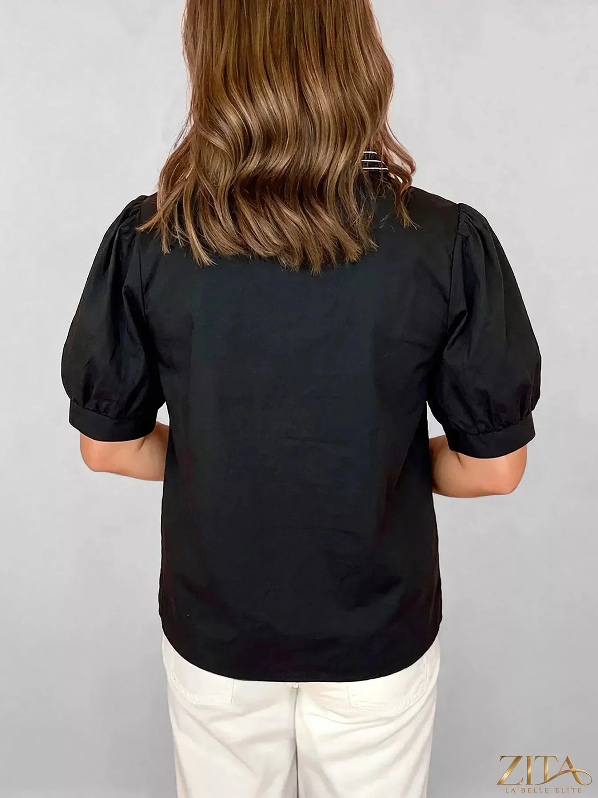 Zita La Belle Elite notched puff sleeve blouse with ruffled details and V-neck, shown in a stylish black fabric.