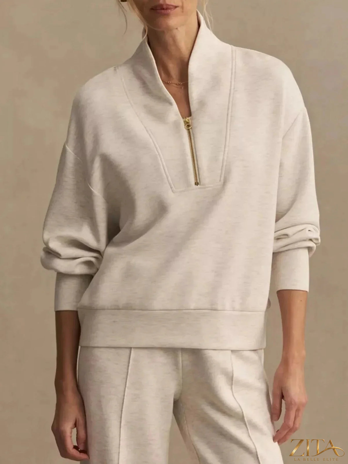 Zita La Belle Elite quarter-zip sweatshirt and wide-leg pants set, soft fabric, in neutral tones, displayed on a model.