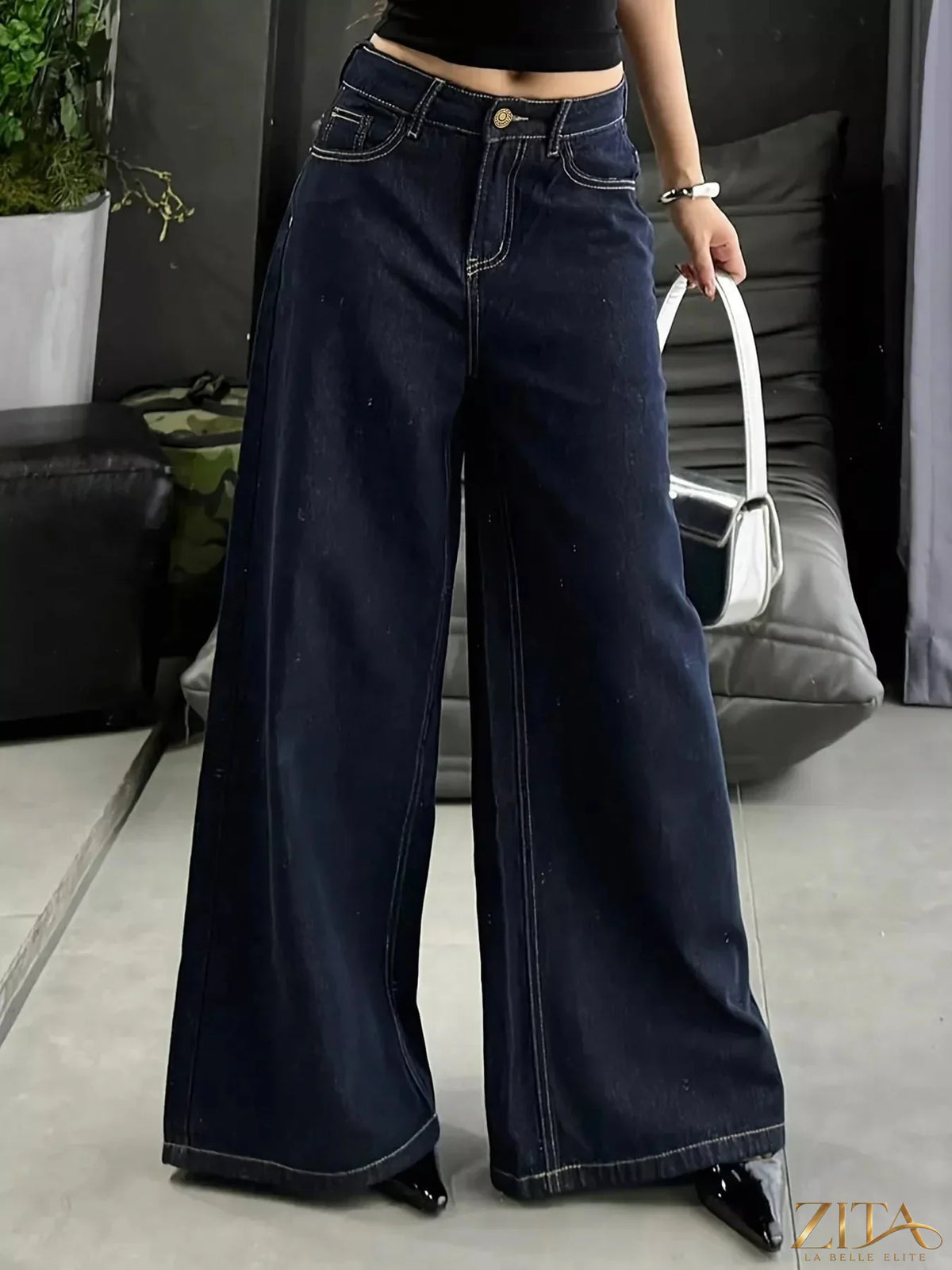 Zita La Belle Elite wide leg jeans with a high waist and light wash denim, styled with front pockets and rolled cuffs.