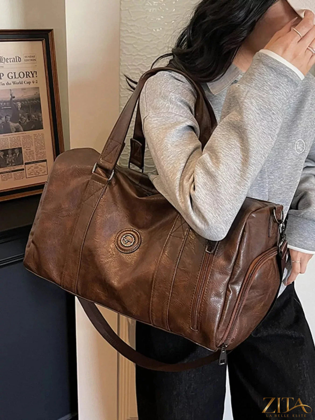 Trendsi PU leather duffel bag with dual handles, zipper closure, and spacious interior for travel or gym use.