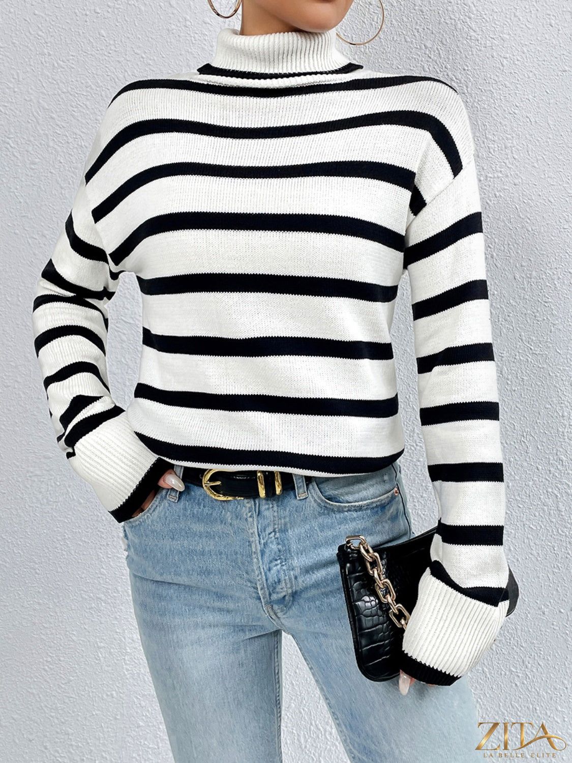 Striped turtleneck drop shoulder sweater by Trendsi featuring a cozy fit and bold horizontal stripes in neutral and vibrant colors.