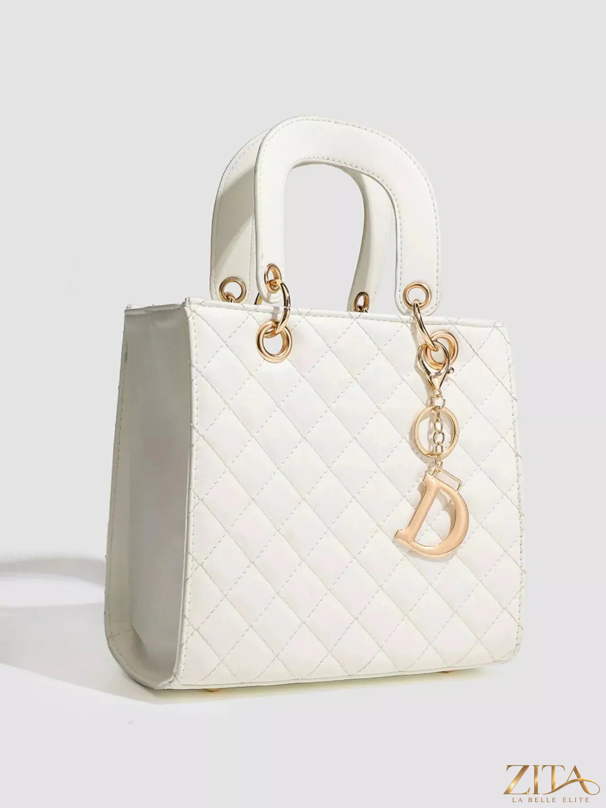 Zita La Belle Elite quilted top handle handbag with sleek design and gold hardware, featuring a structured shape and stitched detailing.