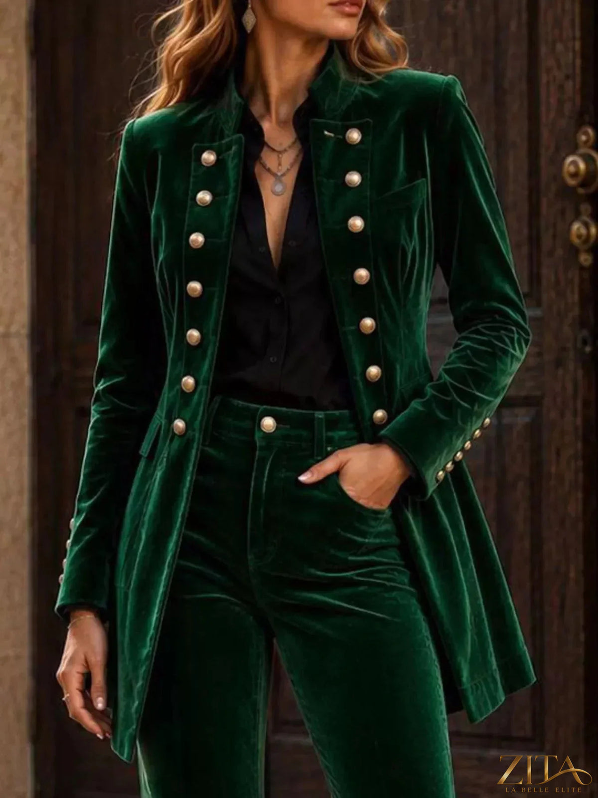 Velvet double-breasted blazer and flare pants set by Zita La Belle Elite, shown on a model with stylish accessories.