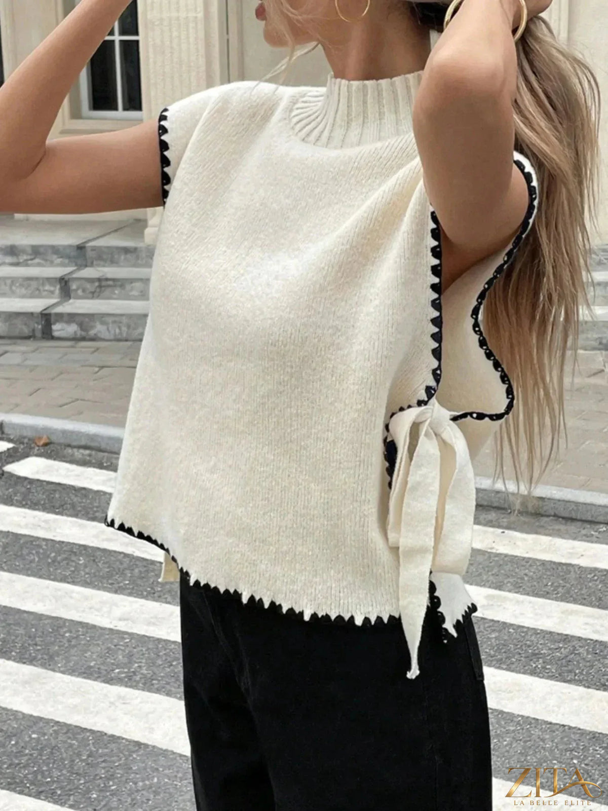 Ribbed turtleneck sweater vest with contrast trim, stylish knit design, worn by a model showcasing the trendy Trendsi top.