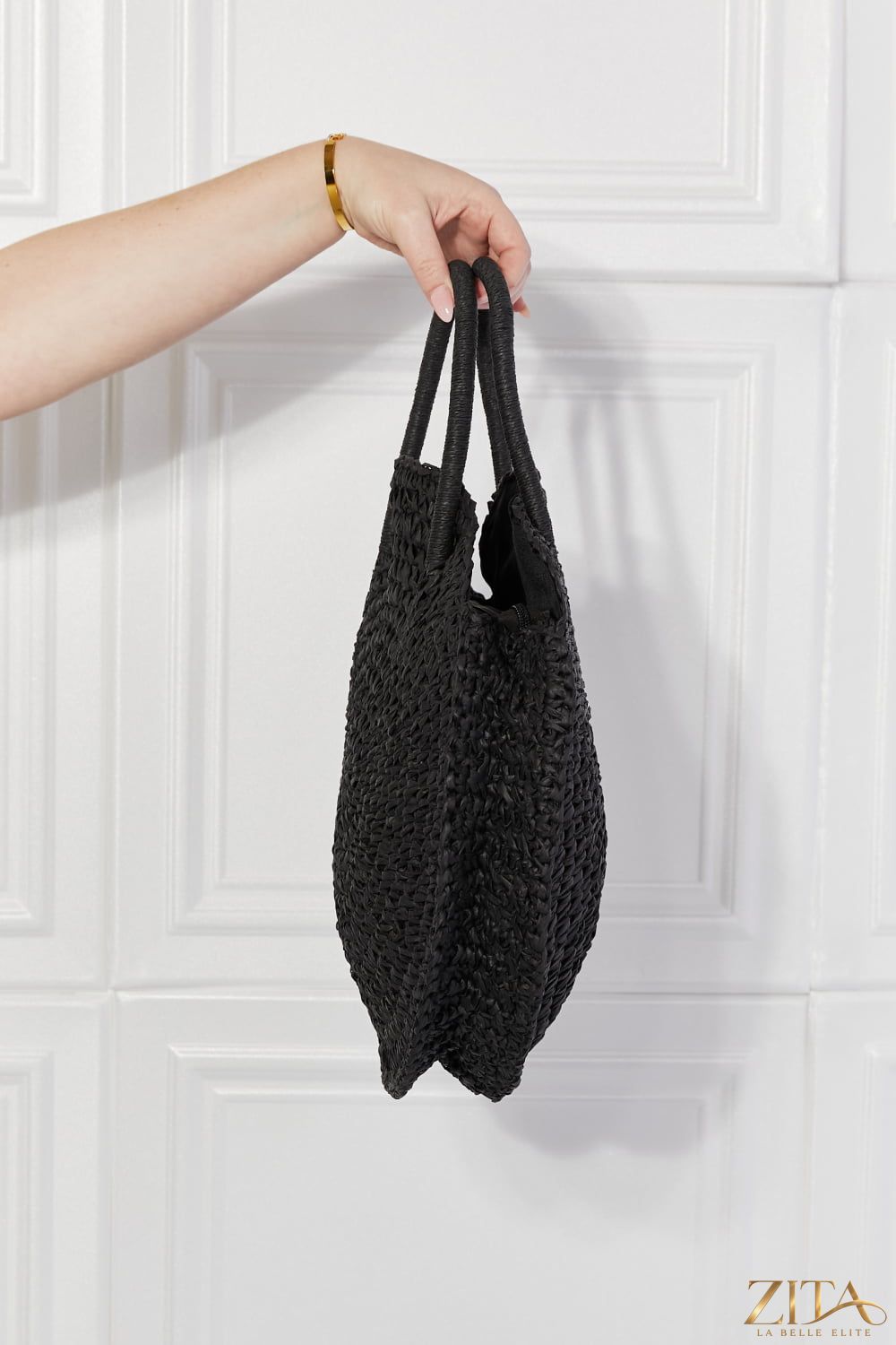 Justin Taylor Beach Date straw rattan handbag in black, stylish Zita La Belle Elite accessory with woven design and shoulder strap.