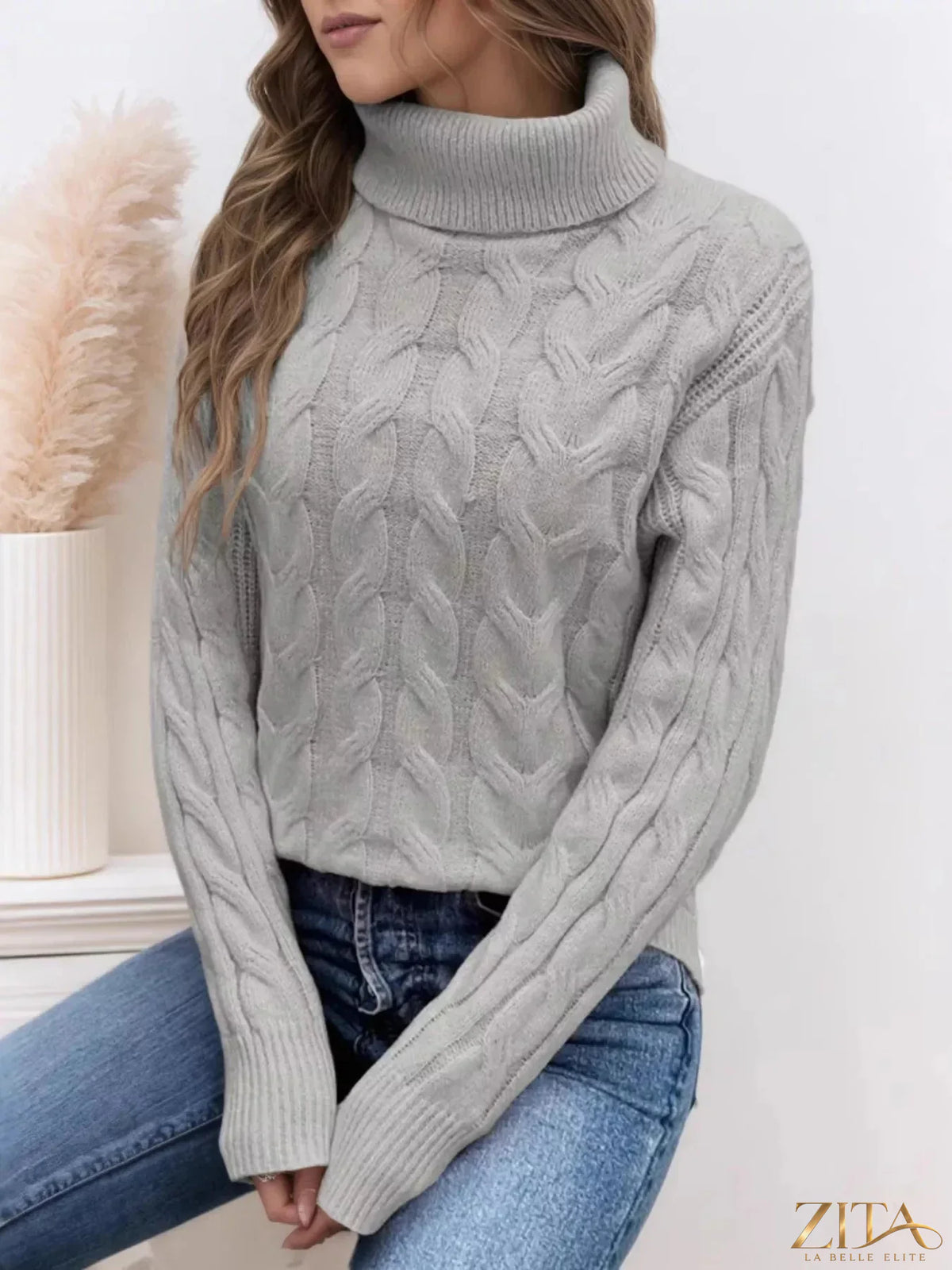 Zita La Belle Elite cable-knit turtleneck sweater in cozy wool with a classic turtleneck design and textured knit pattern.