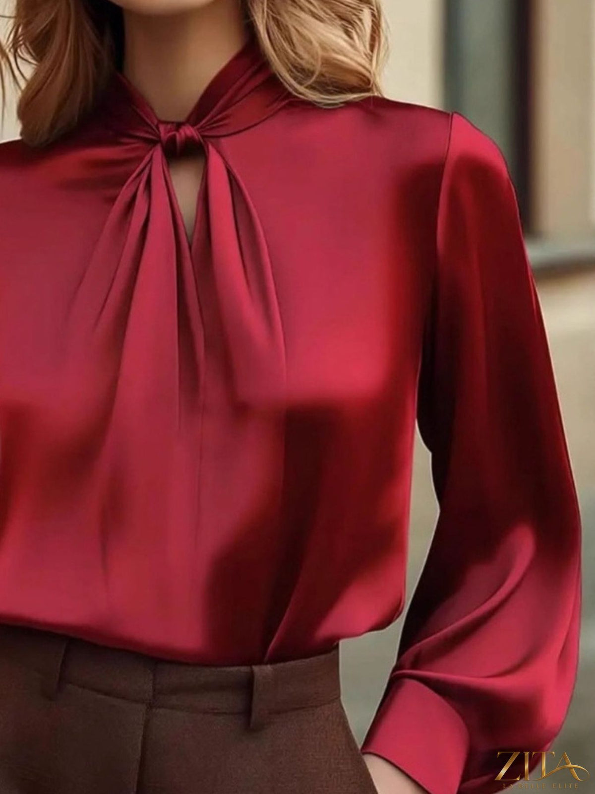 Zita La Belle Elite satin cutout front blouse featuring a stylish neckline and elegant design, worn by a model.