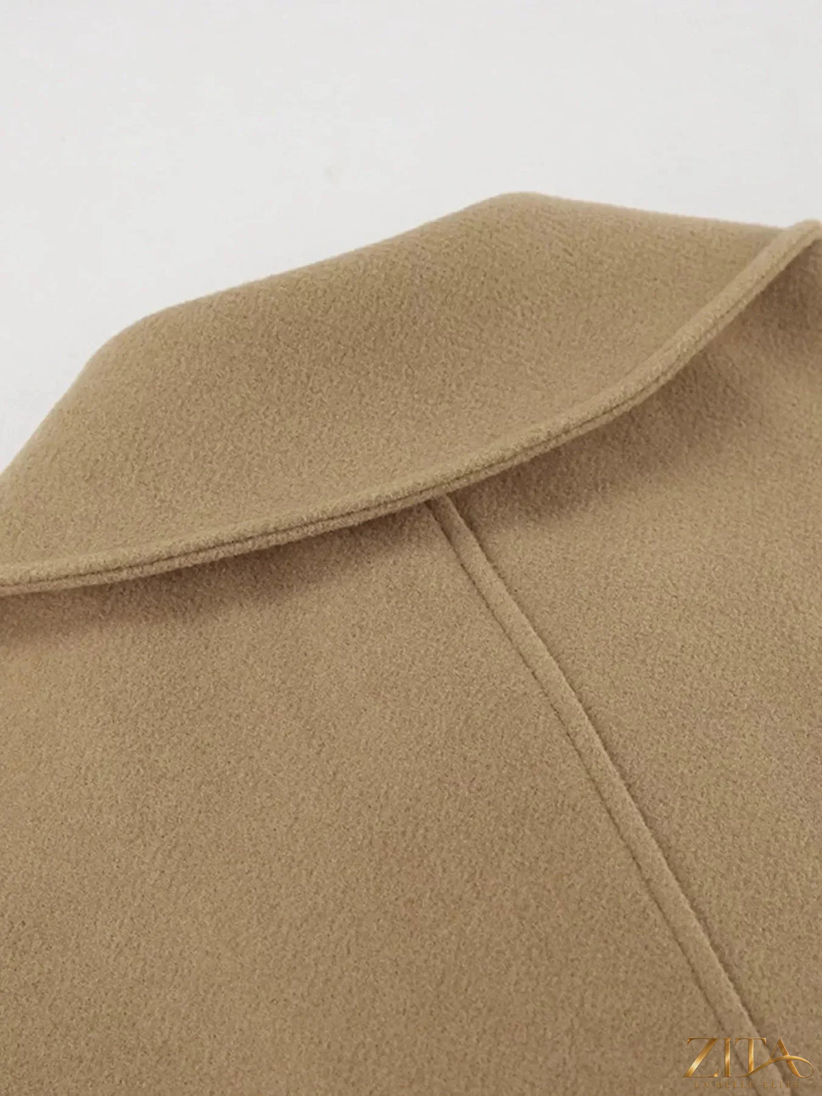 Zita La Belle Elite oversized coat with a lapel collar and button-down front, shown hanging on a wooden hanger.