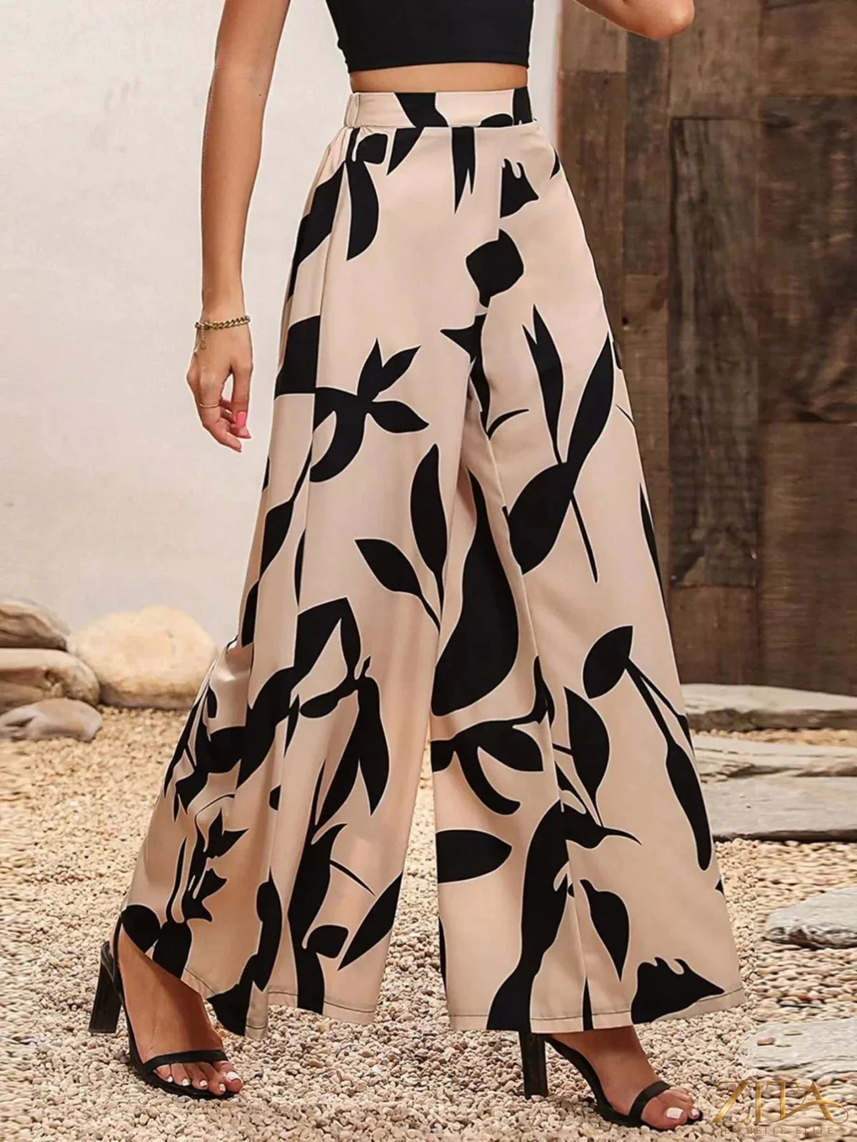 Printed wide-leg pants from Zita La Belle Elite, featuring a flowing design and vibrant pattern, displayed on a hanger.
