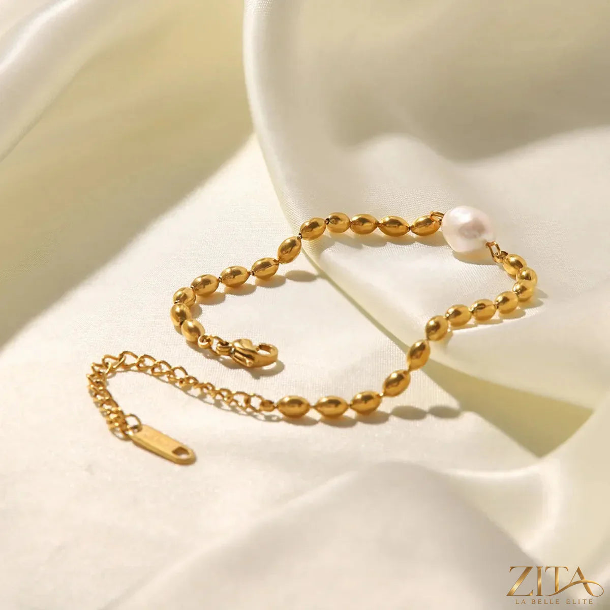 Pearl and gold chain jewelry set with matching necklace and bracelet, featuring elegant pearls and gold accents.
