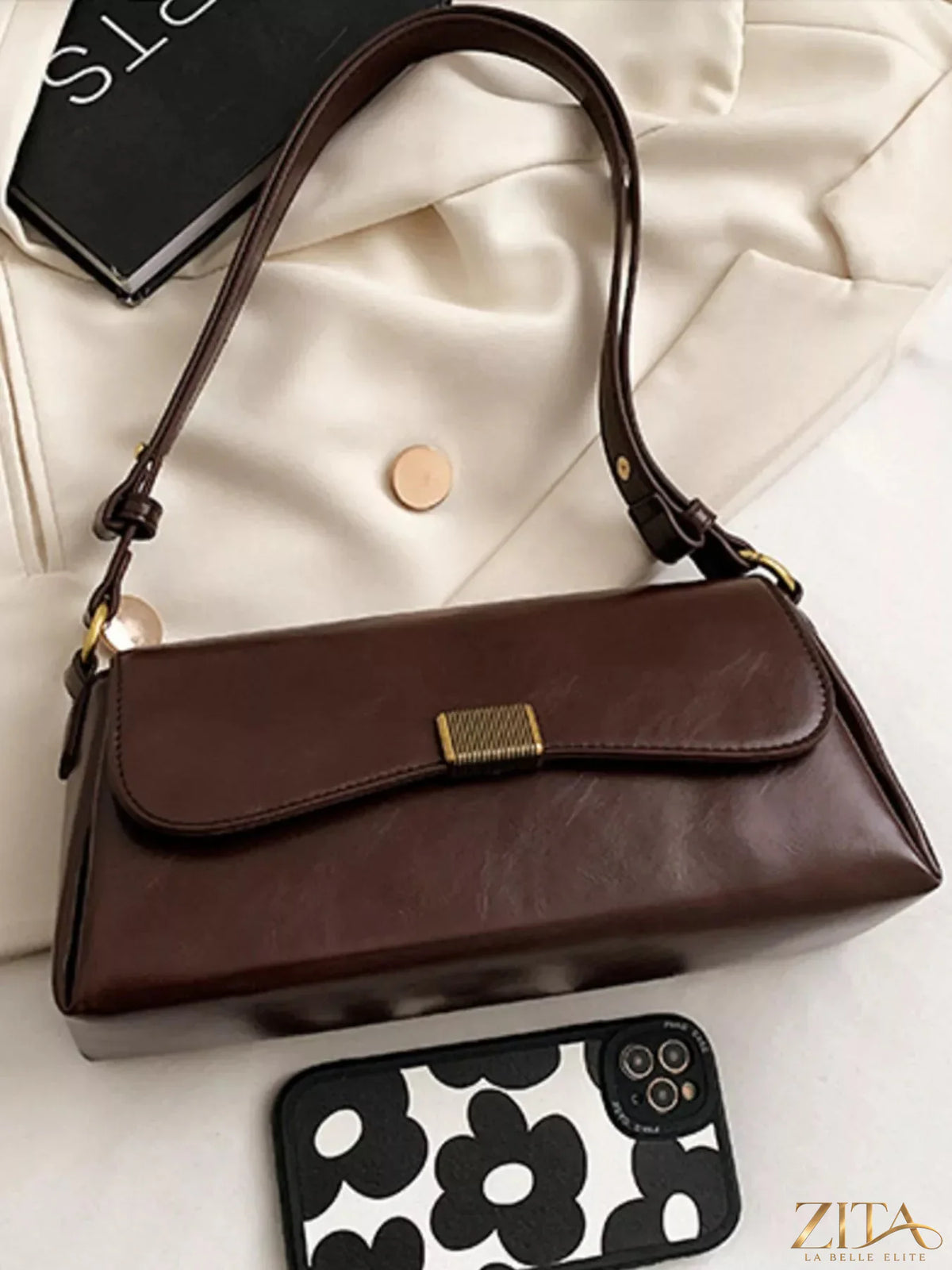 Leather flap shoulder bag by Trendsi featuring a sleek design and adjustable strap, perfect for stylish everyday use.