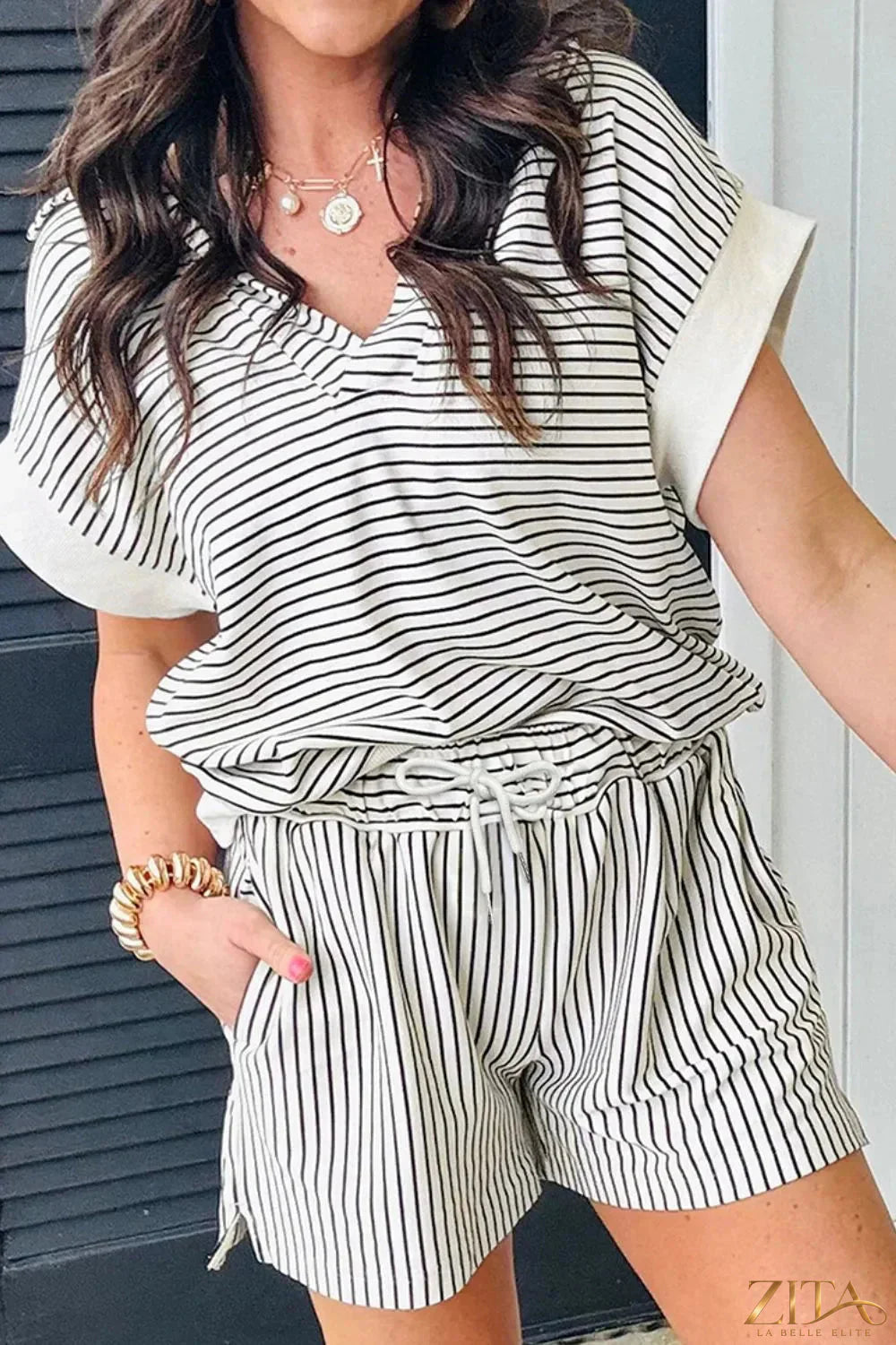 Stripe V-neck tee and casual shorts set by Trendsi, featuring a relaxed two-piece outfit with a striped design and comfortable fit.