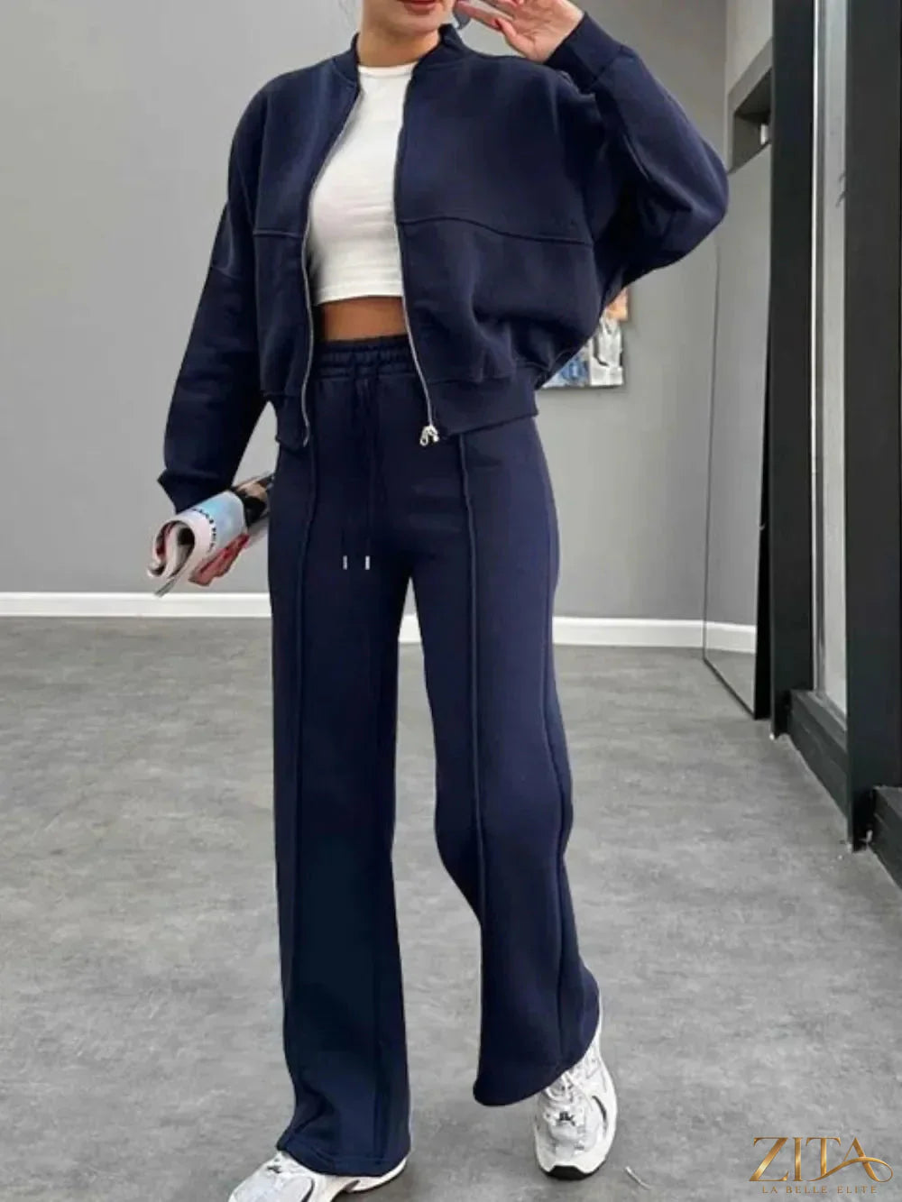 Zita La Belle Elite baseball collar zip-up outerwear and drawstring pants set, white with navy accents, on a hanger.