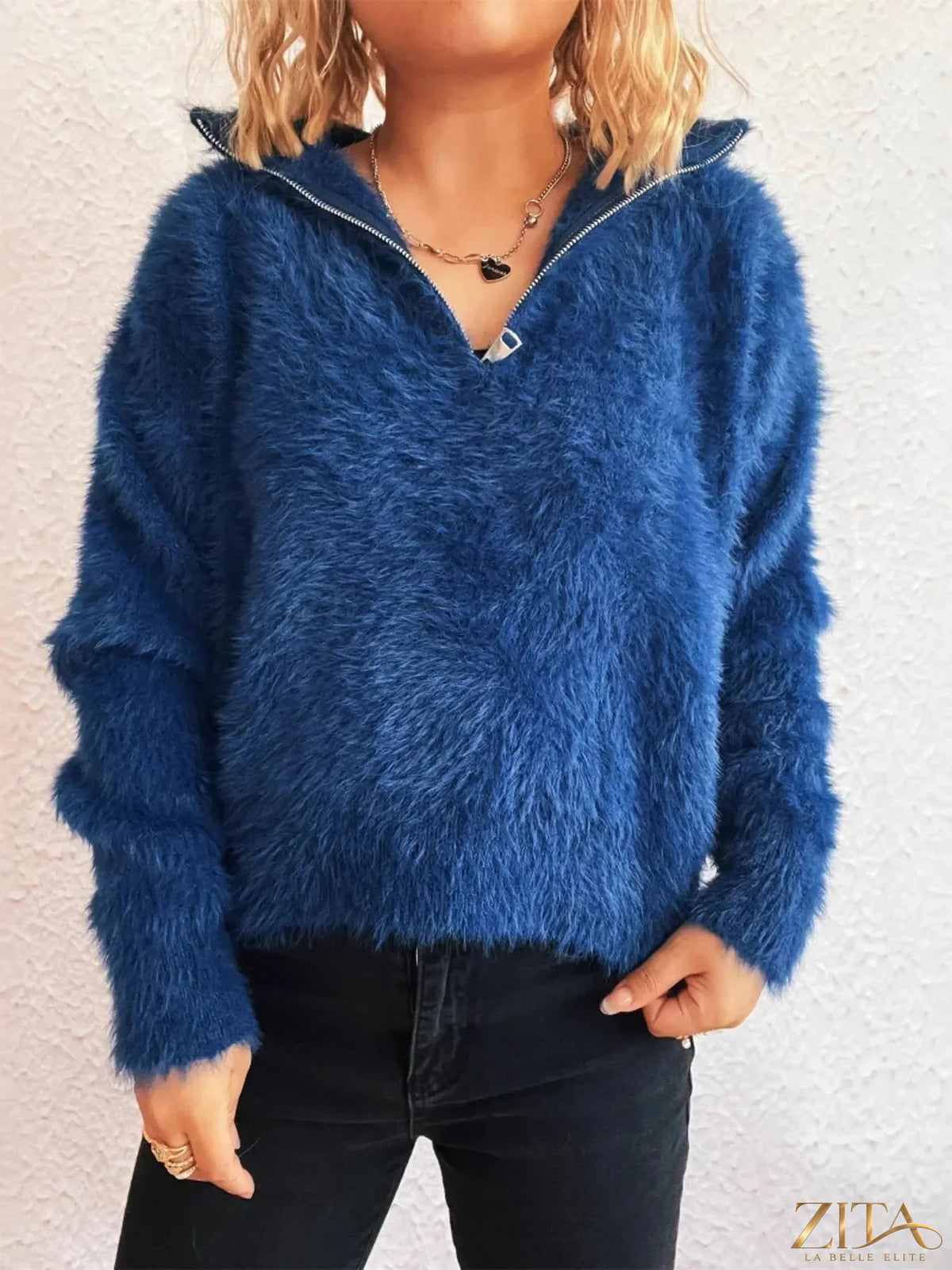 Zita La Belle Elite cozy fuzzy half-zip sweater in soft, warm fabric with a high collar and relaxed fit, displayed on a hanger.