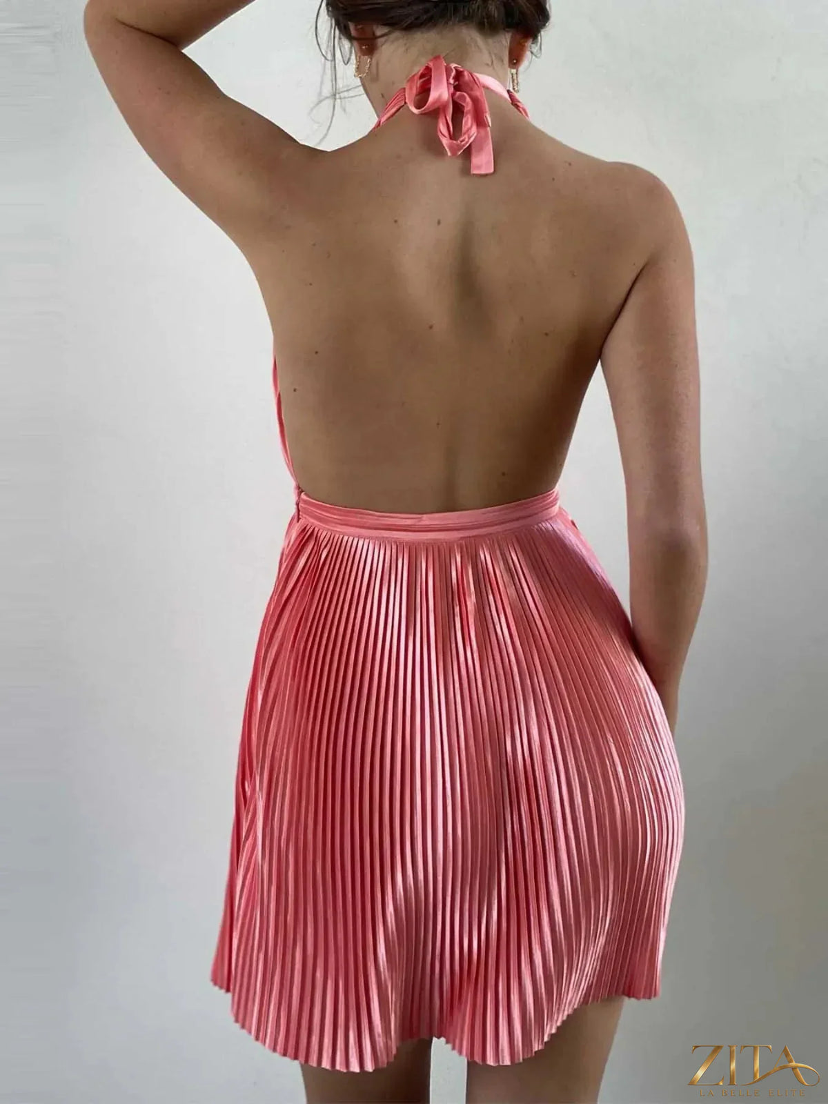 Trendsi pleated halter neck mini dress with a fitted bodice and flowing skirt, perfect for summer or casual occasions.
