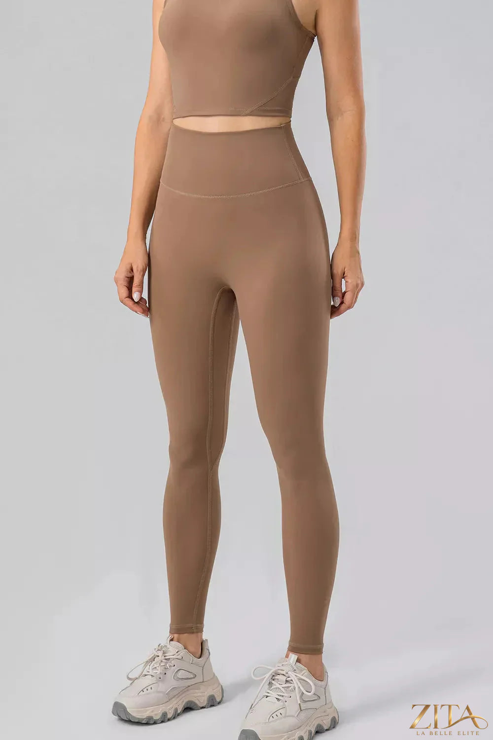 High waist active leggings with wide waistband from Trendsi, shown in black, featuring a snug fit and stretchy fabric for workout comfort.
