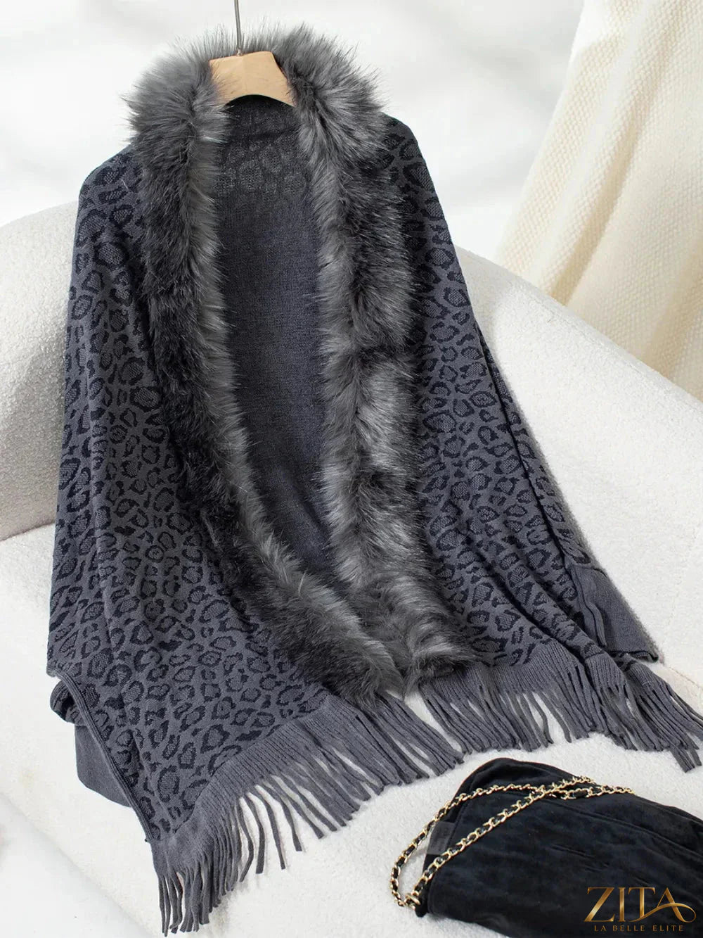 Leopard print fringe open front long sleeve poncho by Trendsi featuring a stylish, flowy design and boho-inspired details.