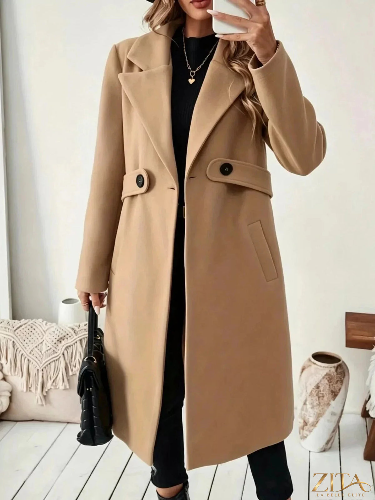 Zita La Belle Elite single-button longline coat in neutral fabric, shown on a hanger with a minimalist background.