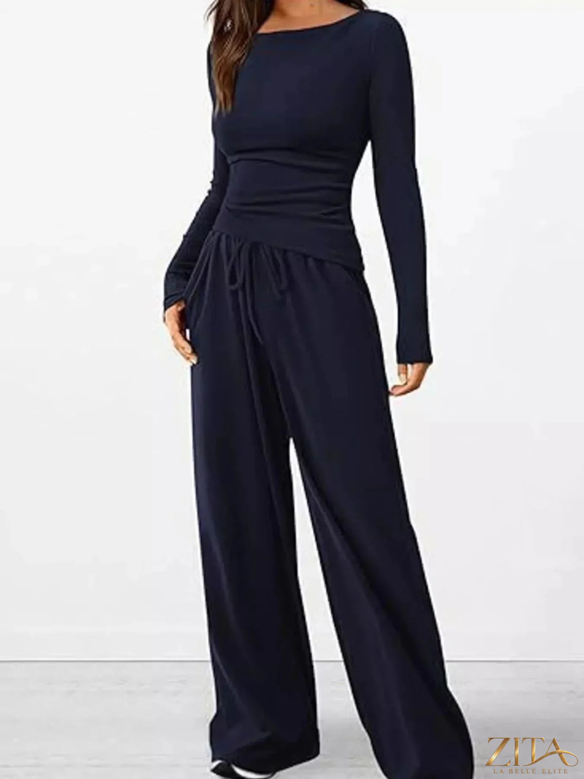 Zita La Belle Elite long sleeve top and wide-leg pants set in neutral fabric, displayed on a hanger against a white background.