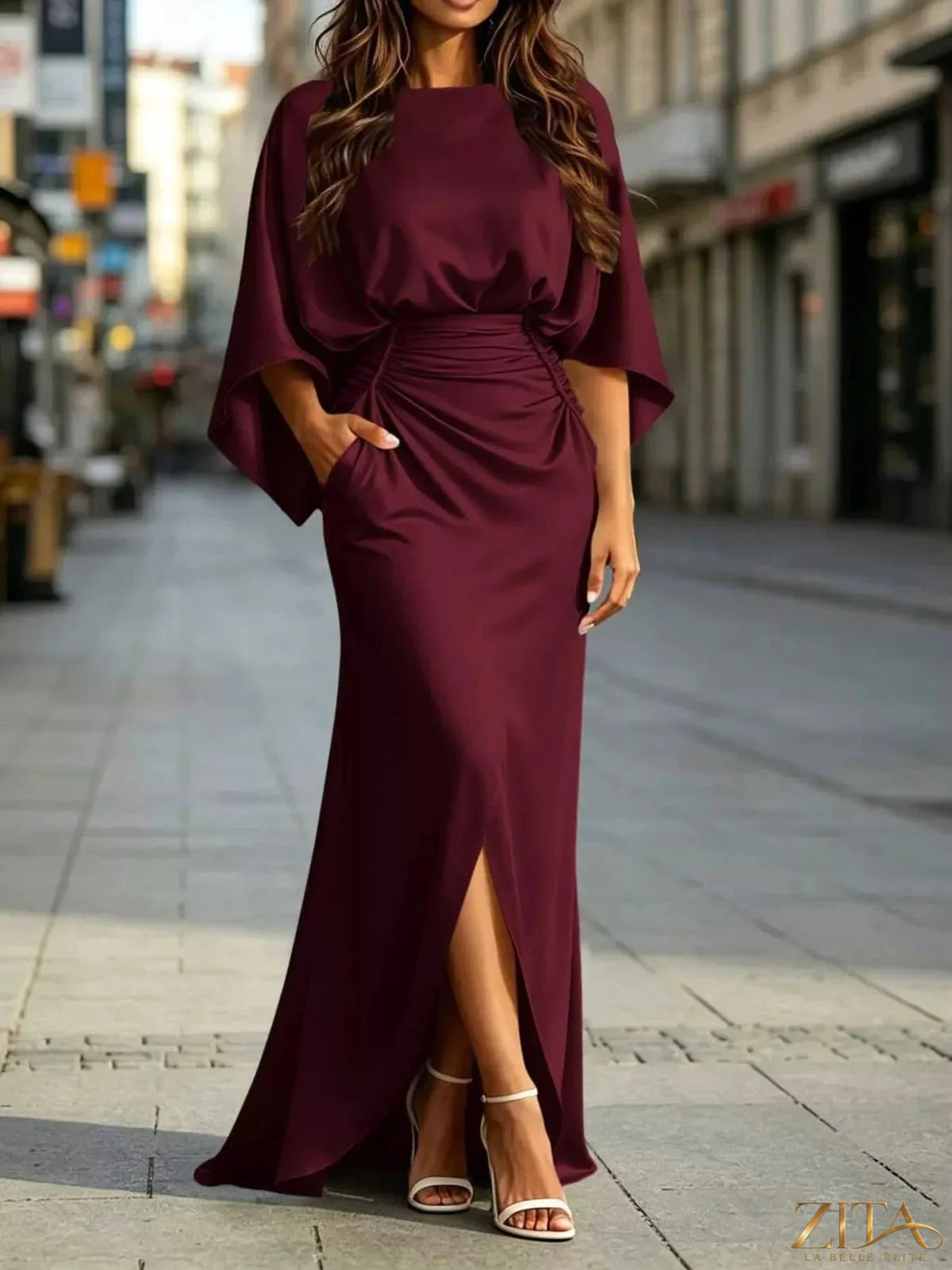 Zita La Belle Elite ruched waist maxi dress with pockets, flowing fabric, and elegant design, shown on a model.