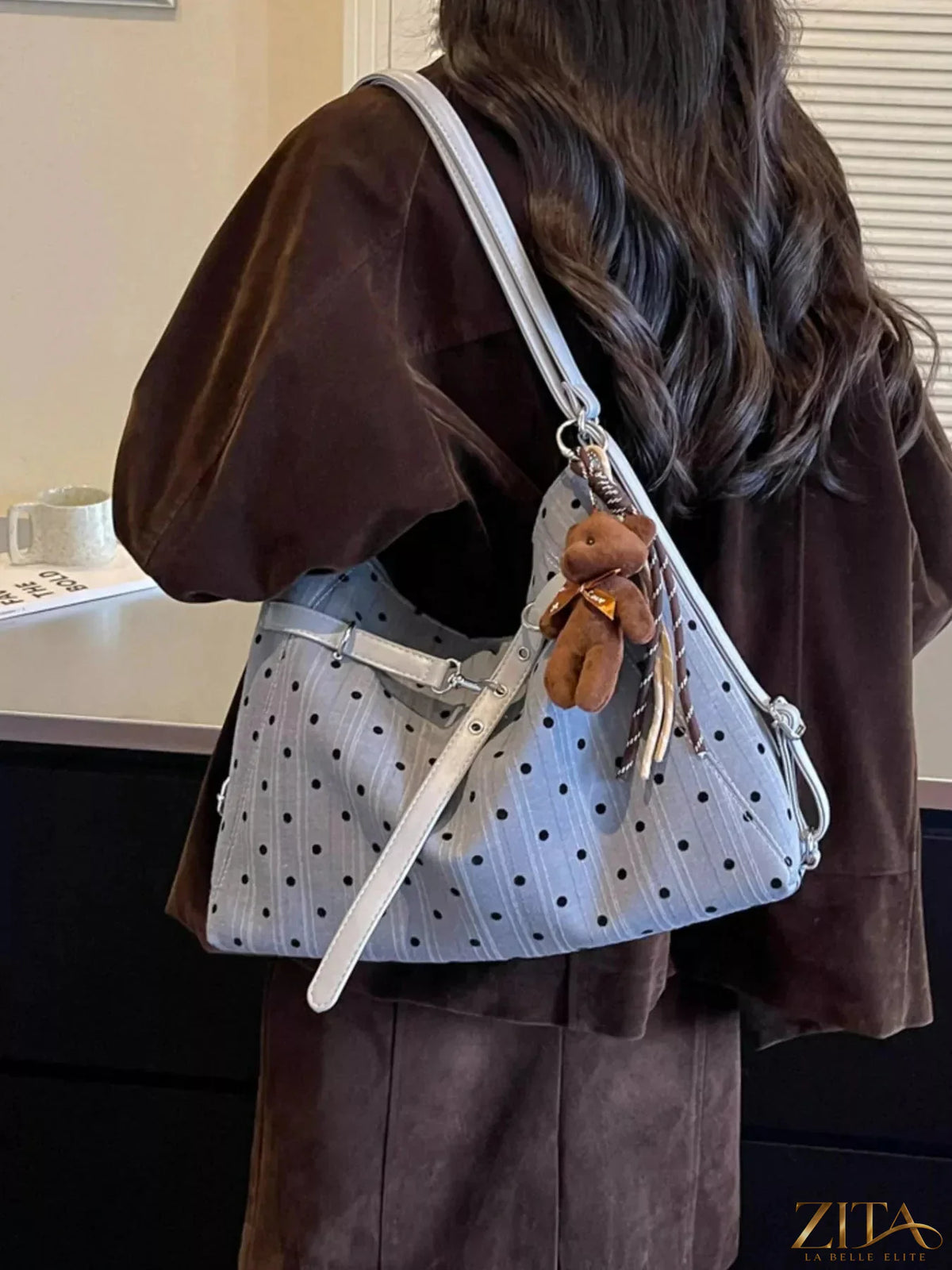 Zita La Belle Elite polka dot shoulder bag with adjustable strap and zip closure, featuring a stylish black and white polka dot pattern.