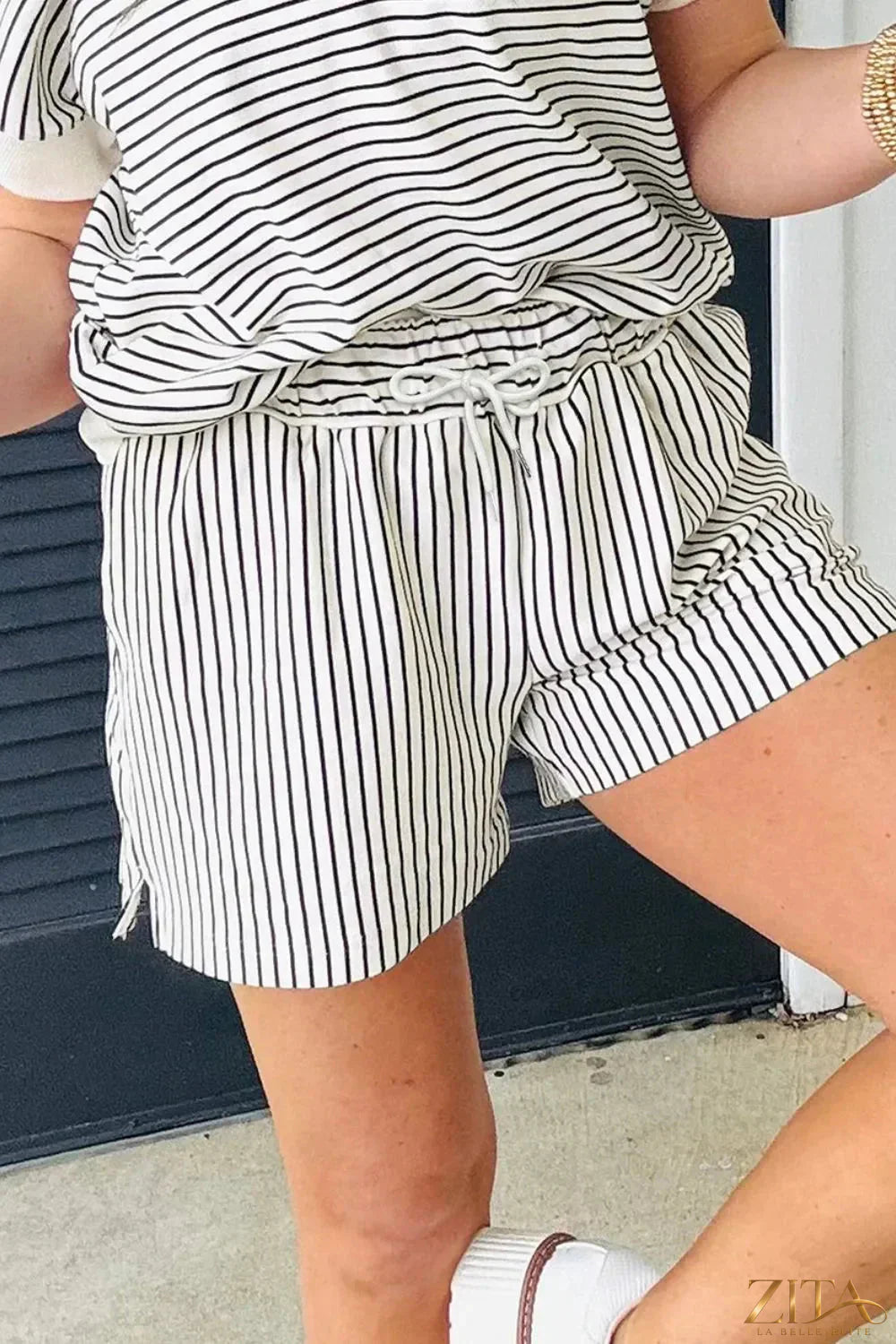 Stripe V neck tee and casual shorts set by Trendsi, featuring a relaxed fit and comfortable two-piece outfit for everyday wear.
