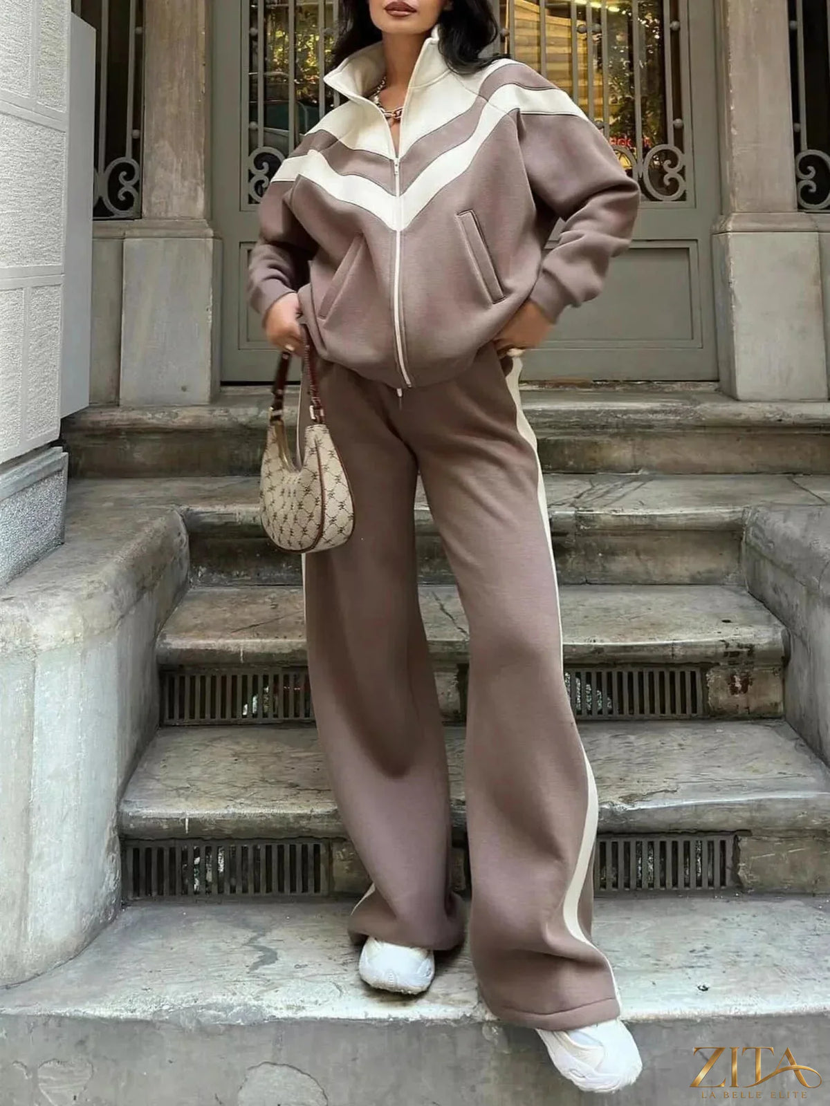 Color block zip-up outerwear and pants set by Zita La Belle Elite, featuring vibrant color blocking and a sleek athletic style.