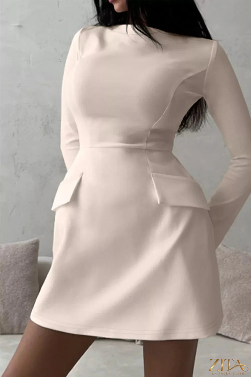Long-sleeve mini dress with flap pockets by Trendsi, featuring a fitted silhouette and stylish design, shown on a model.
