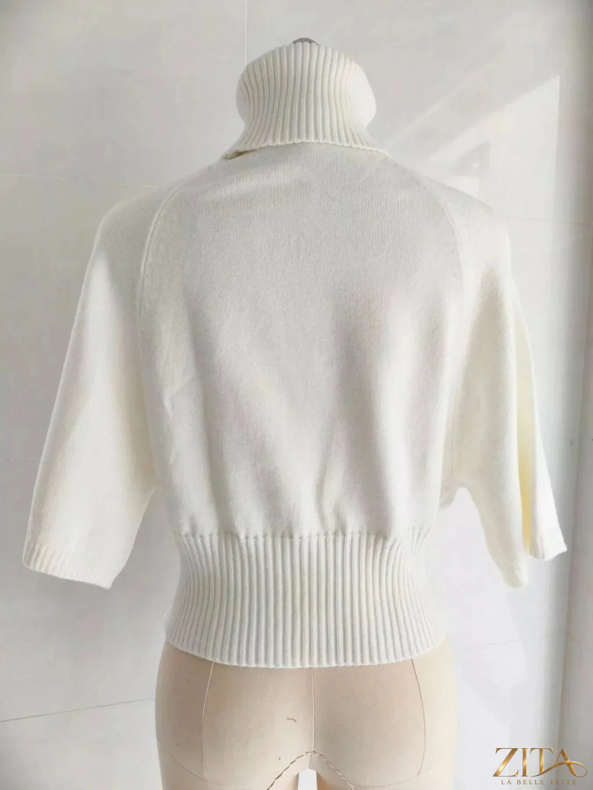 Black turtleneck batwing sleeve sweater by Trendsi, featuring a cozy knit design and relaxed fit, displayed on a neutral background.