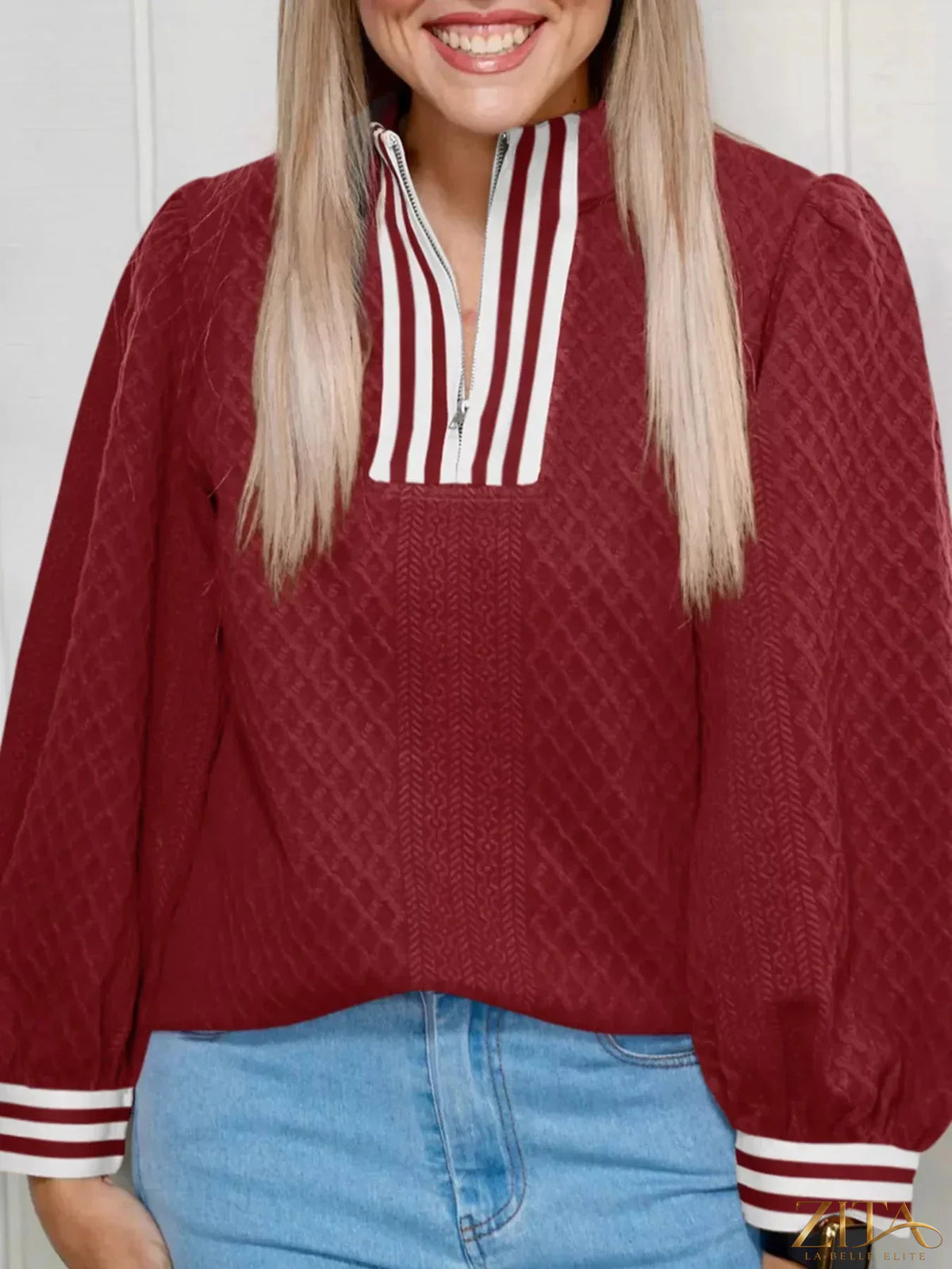 Zita La Belle Elite striped trim zipper blouse featuring a stylish design with a front zipper and contrasting trim details.