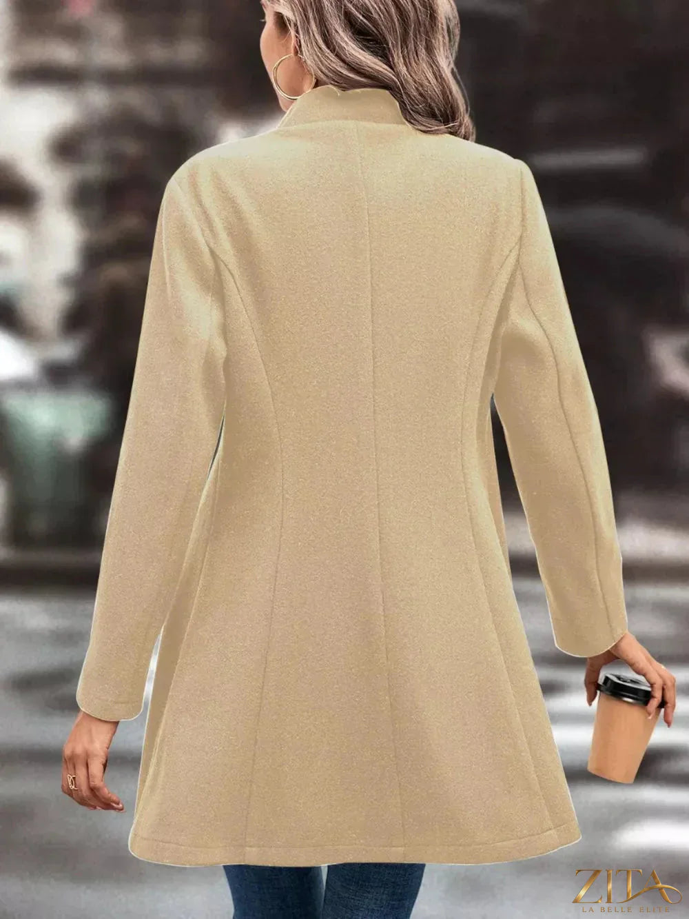Zita La Belle Elite button-up longline coat in neutral fabric, featuring a collar and front buttons on a model.