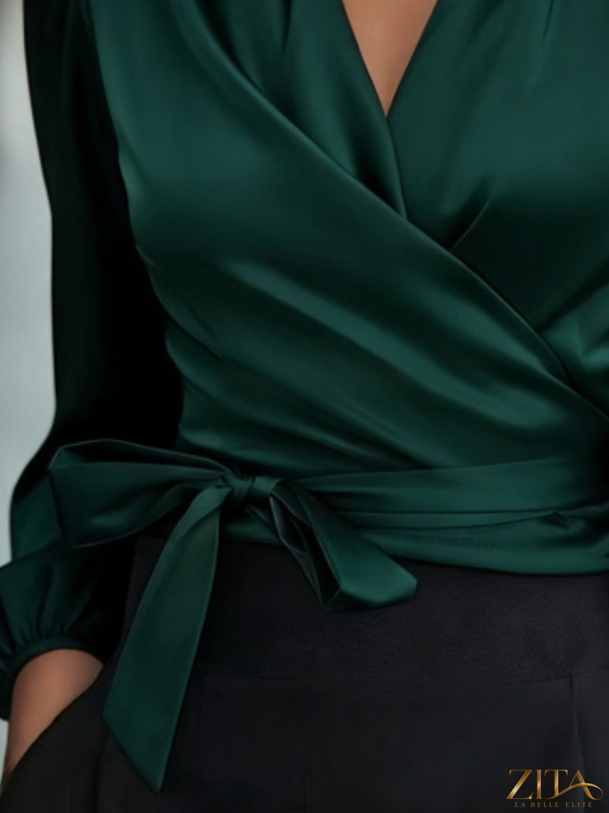 Zita La Belle Elite satin tie waist wrap blouse featuring long sleeves and a V-neck in a soft, elegant fabric.