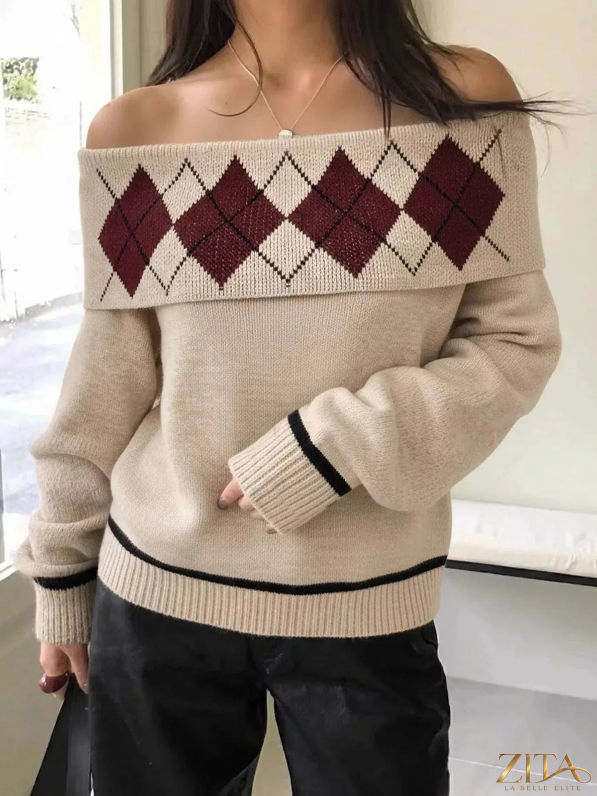 Off-shoulder argyle pattern sweater from Trendsi, featuring a cozy knit with a stylish off-shoulder design and classic diamond pattern.