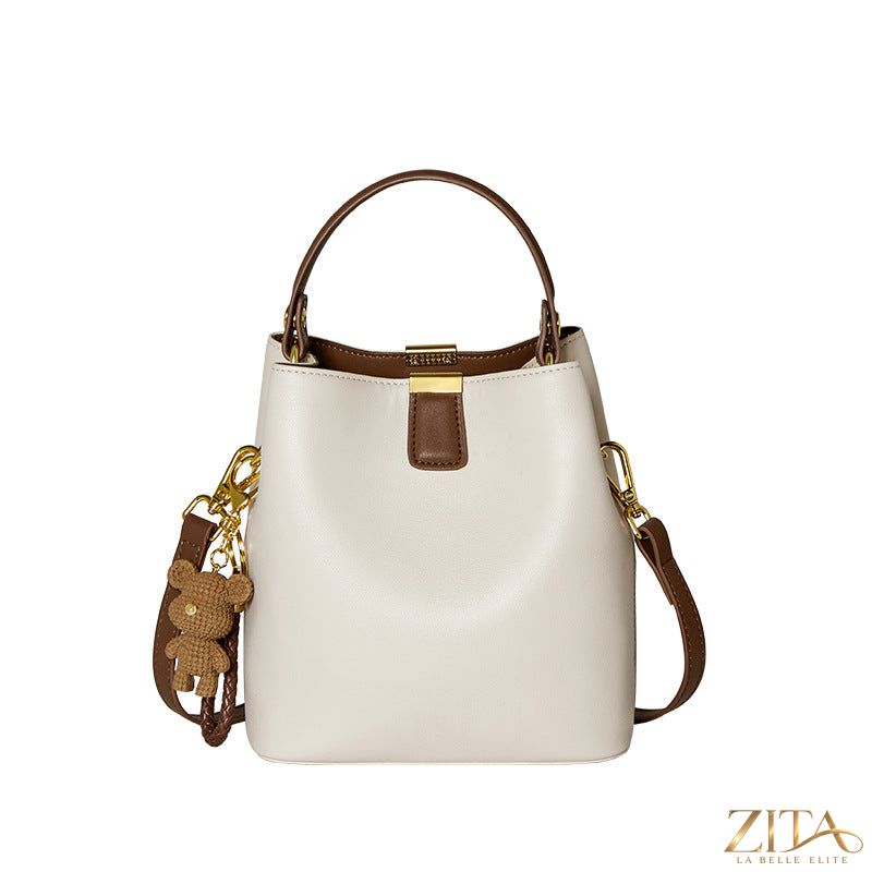 Leather bucket crossbody bag by Trendsi with adjustable strap and spacious interior in smooth leather finish.