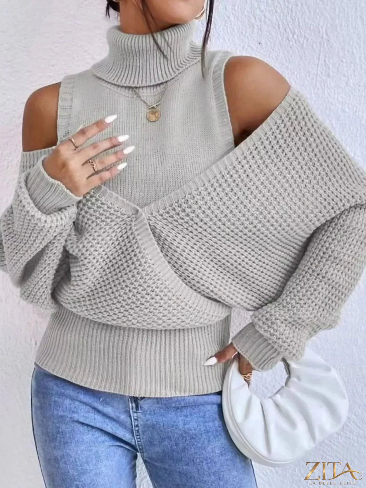 Waffle knit cold shoulder turtleneck sweater by Trendsi, featuring a cozy design with cut-out shoulders and ribbed cuffs.