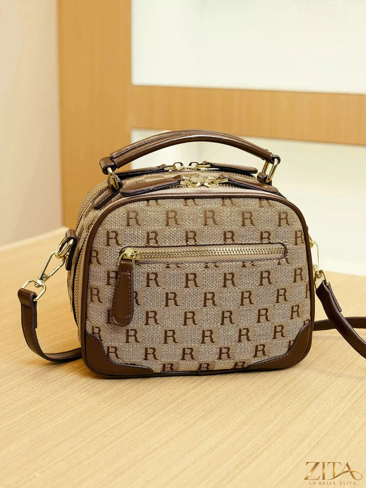 Zita La Belle Elite monogram pattern crossbody handbag with top handle, featuring elegant design and structured shape.