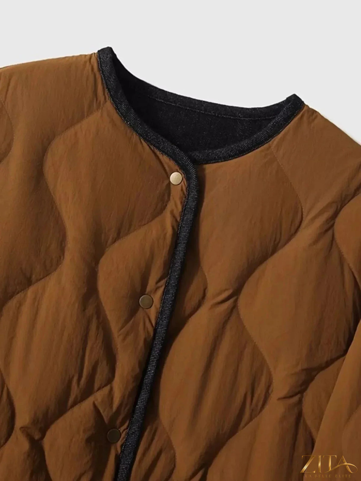 Diamond-quilted lightweight cropped reversible down jacket by Zita La Belle Elite, showing the quilted exterior and reversible design.
