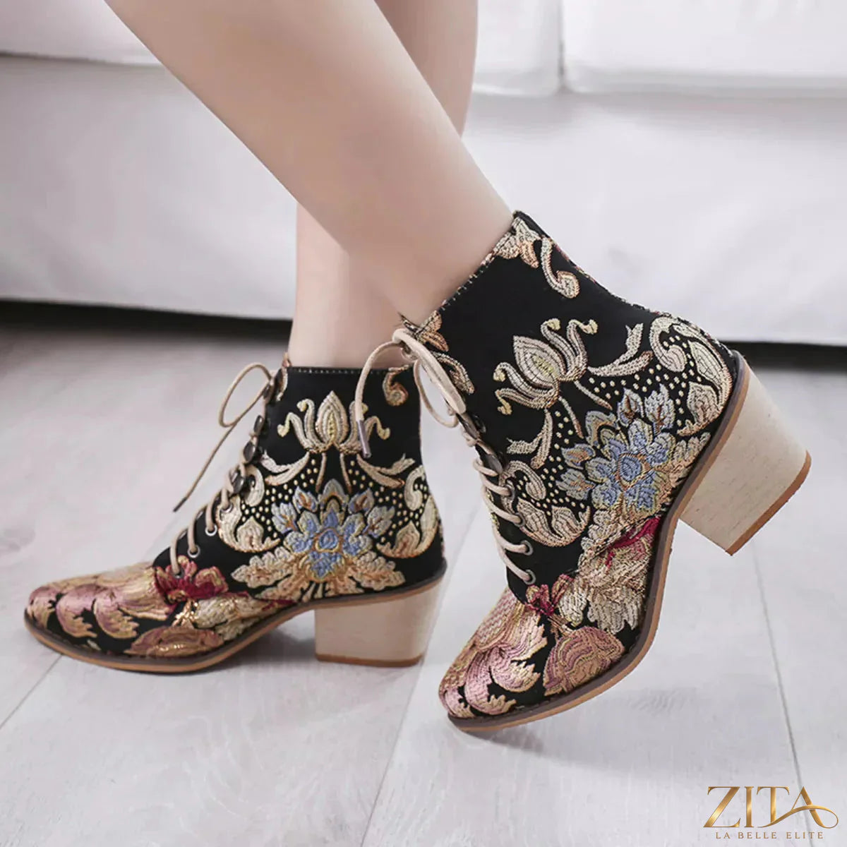 Embossed floral embroidery on black lace-up ankle boots by Zita La Belle Elite, showcasing detailed design and stylish ankle height.