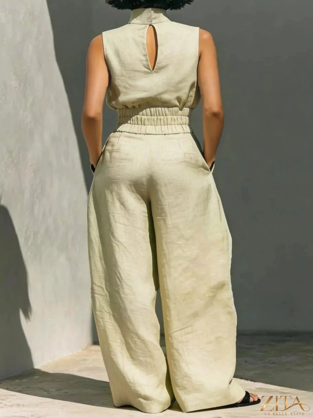 Sleeveless turtleneck top and wide-leg pants set by Trendsi, shown in a stylish outfit with the top tucked into the pants.