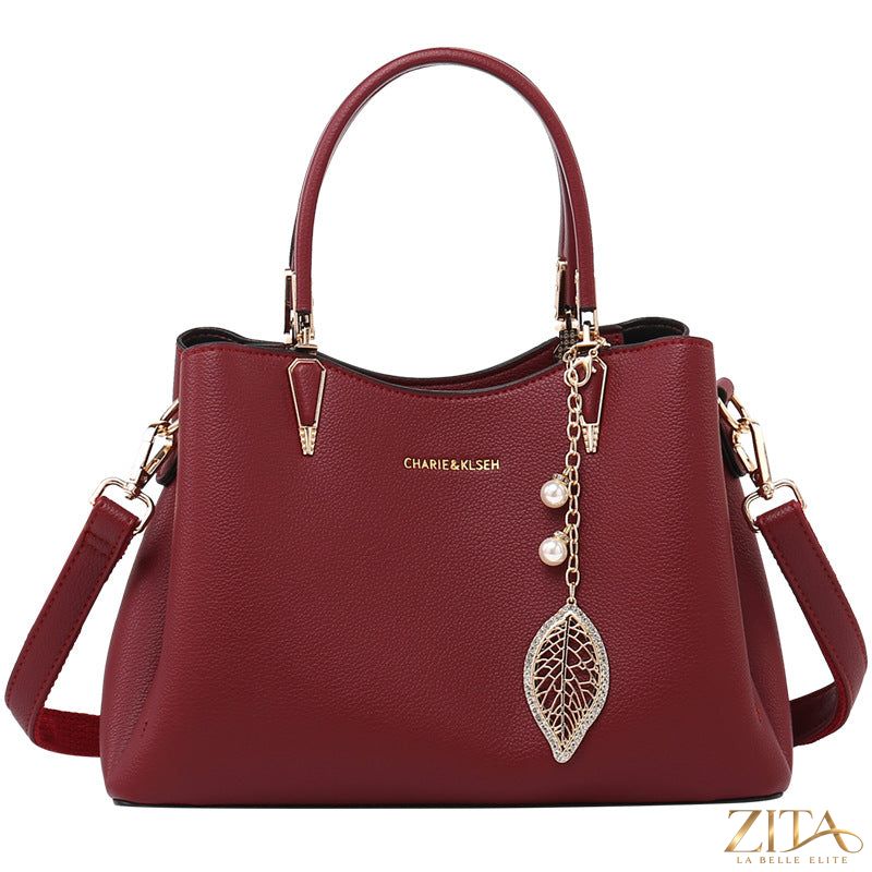 Zita La Belle Elite top-handle leather handbag in classic brown with gold hardware and structured design.