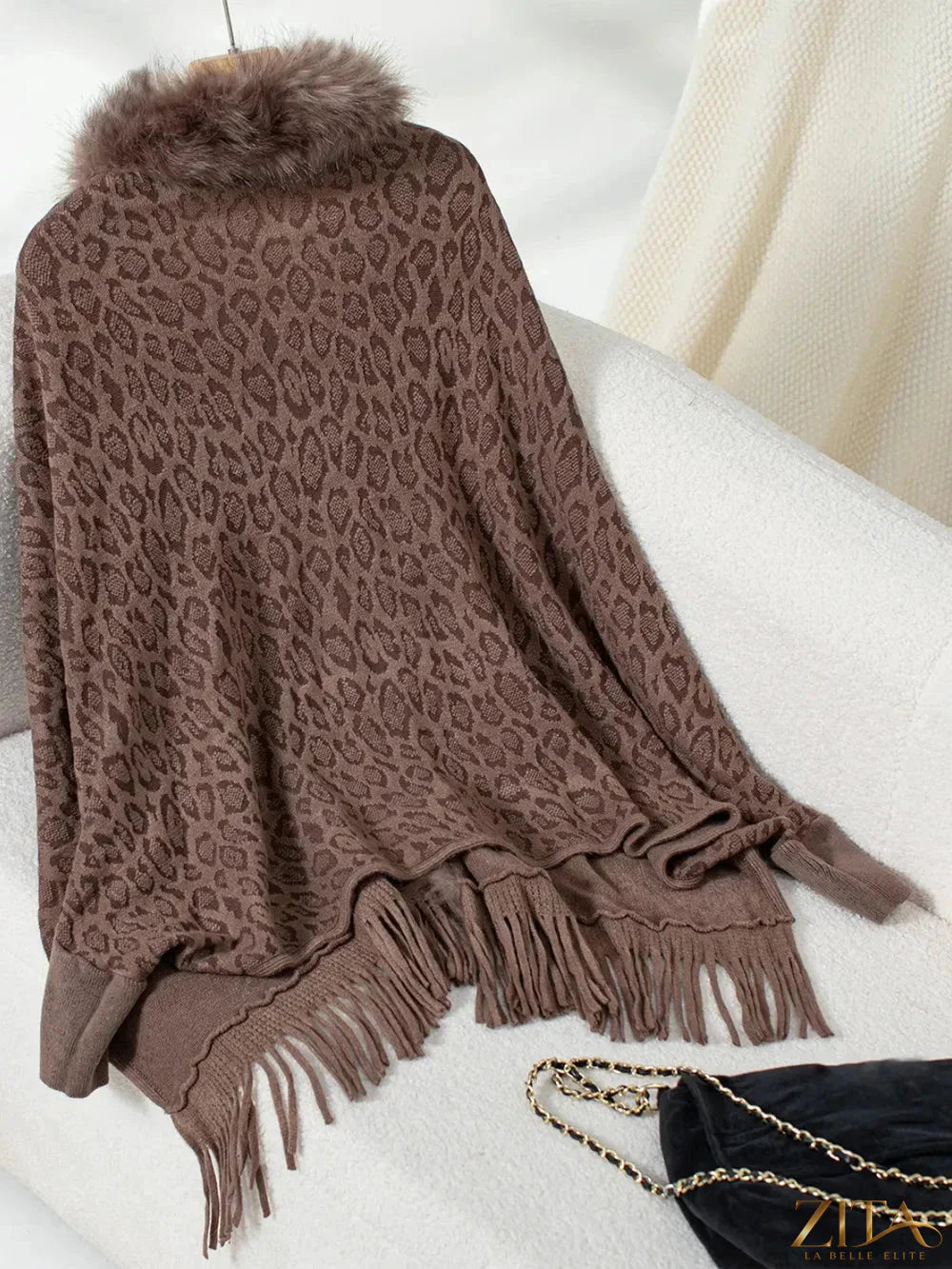 Leopard print fringe open front long sleeve poncho with tassel details, stylish and cozy fashion from Trendsi.