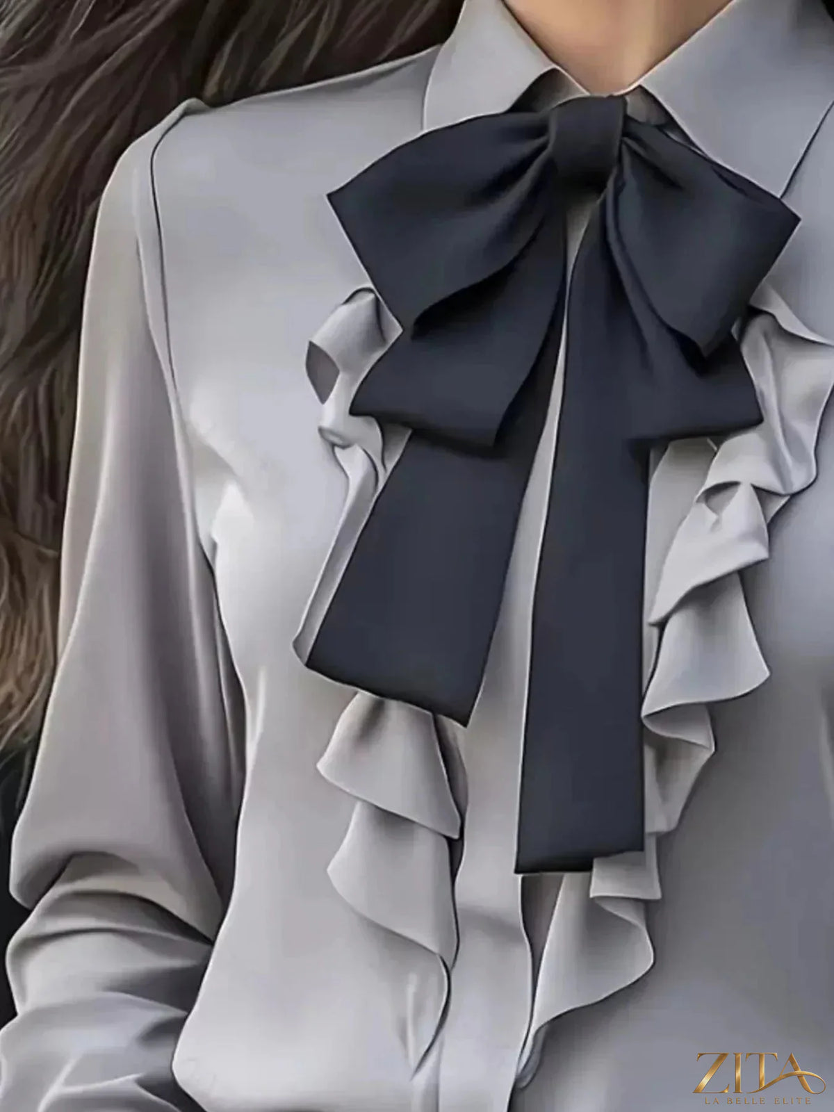 Zita La Belle Elite ruffled tie-front long sleeve blouse with feminine details and lightweight fabric, displayed on a hanger.