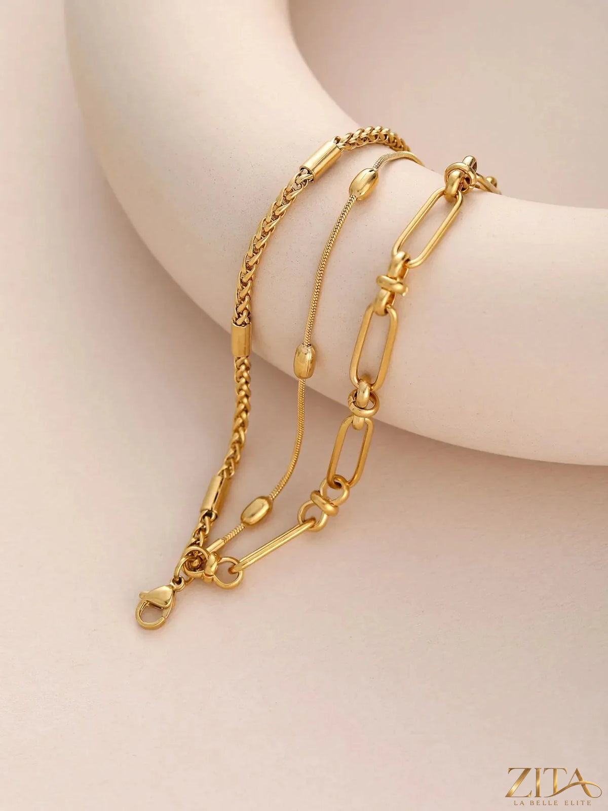 18K gold-plated layered chain necklace and bracelet jewelry set with delicate chains and clasp details, stylish and elegant design.
