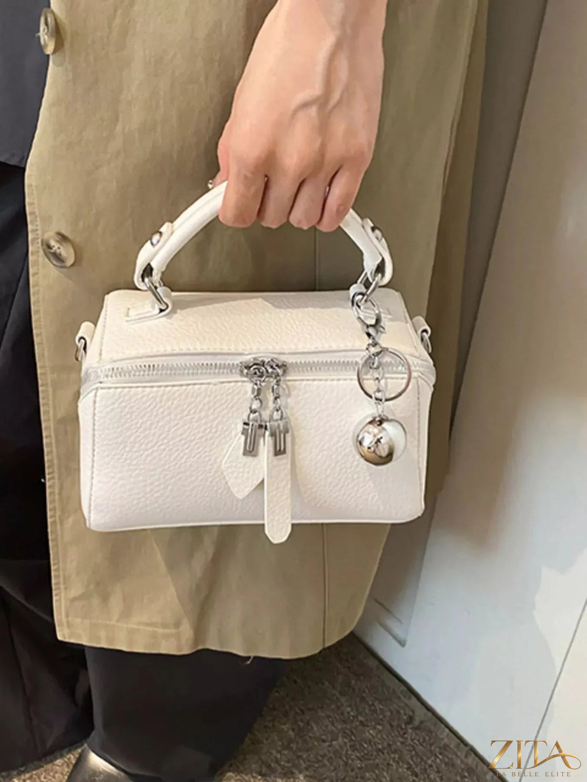 Textured leather handbag by Trendsi featuring a sleek design with top handles and gold-tone hardware.