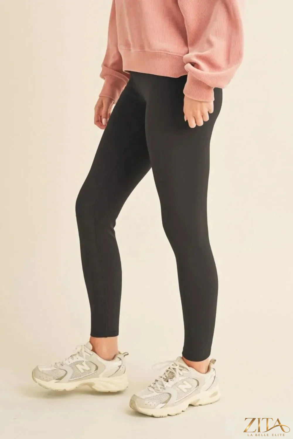 Yelete fleece-lined high-waisted leggings in black, showing their cozy, full-length fit and elastic waistband for comfort.
