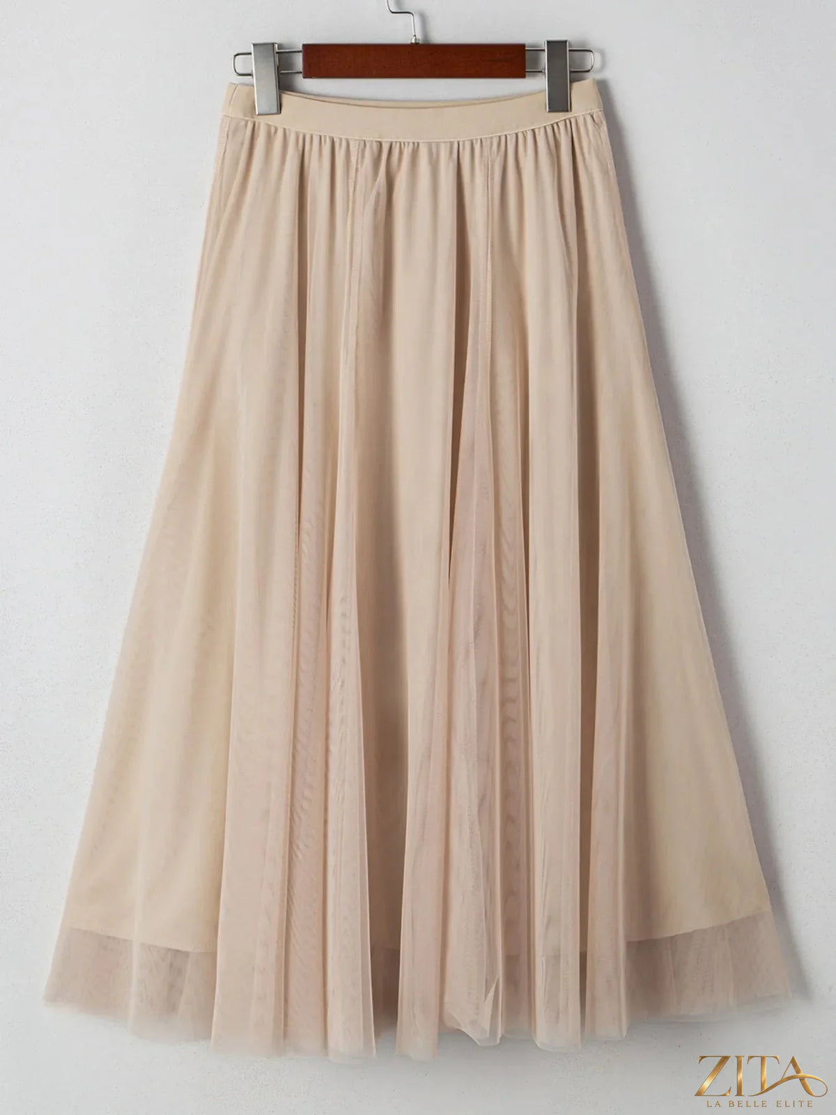 High-waisted midi skirt from Trendsi featuring a flowing design and neutral color, perfect for casual or dressy outfits.