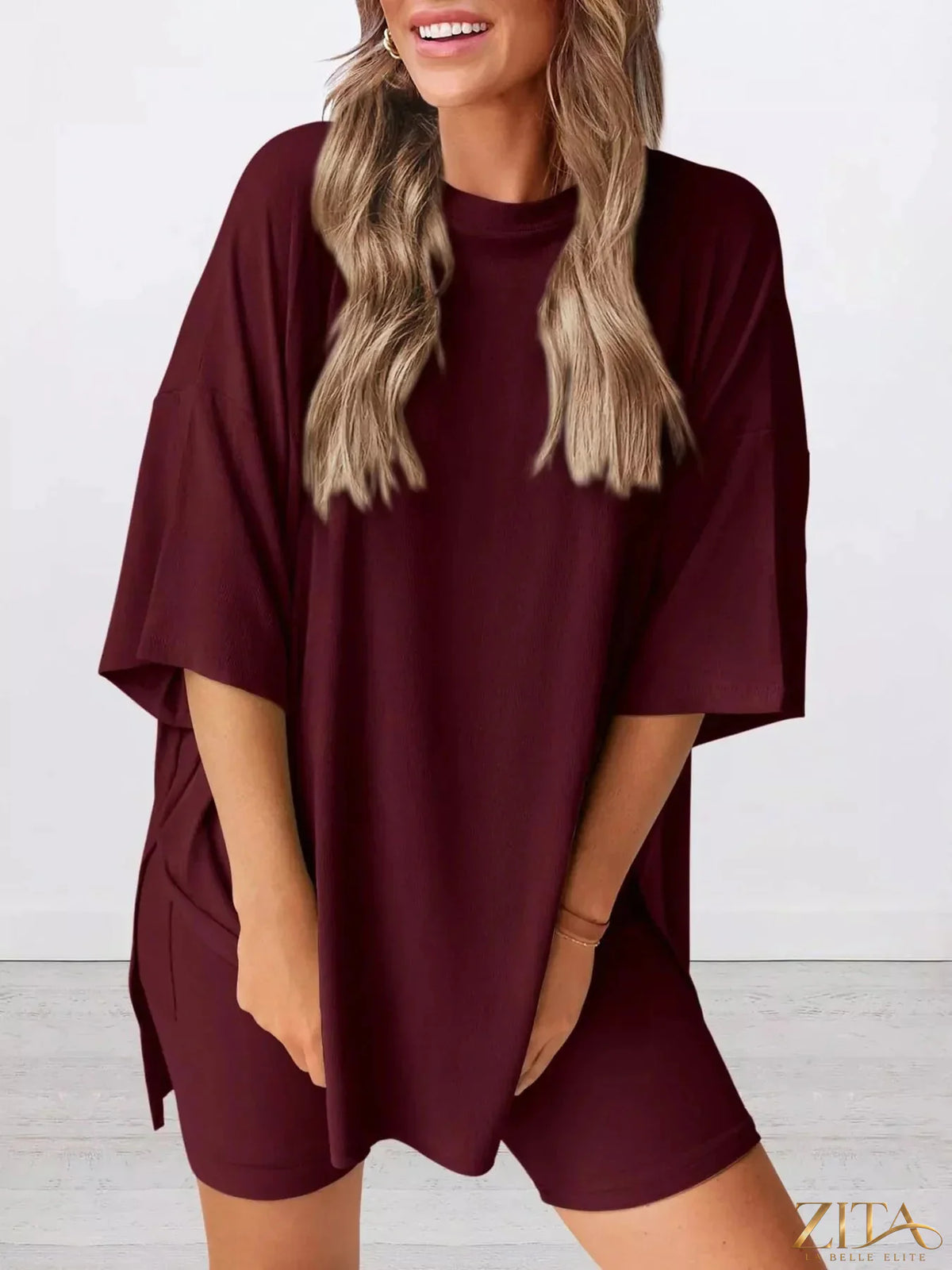 Plus size relaxed fit top and shorts two-piece set by Trendsi, featuring comfortable fabric and casual style.