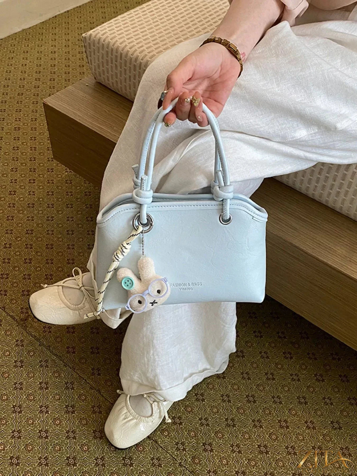 Trendsi PU leather handbag with top handle and gold-tone hardware, featuring a sleek, stylish design and textured finish.