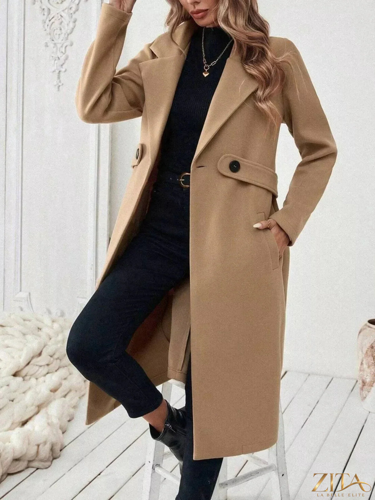 Zita La Belle Elite longline coat with lapel collar, tailored style, in a neutral color, displayed on a hanger.