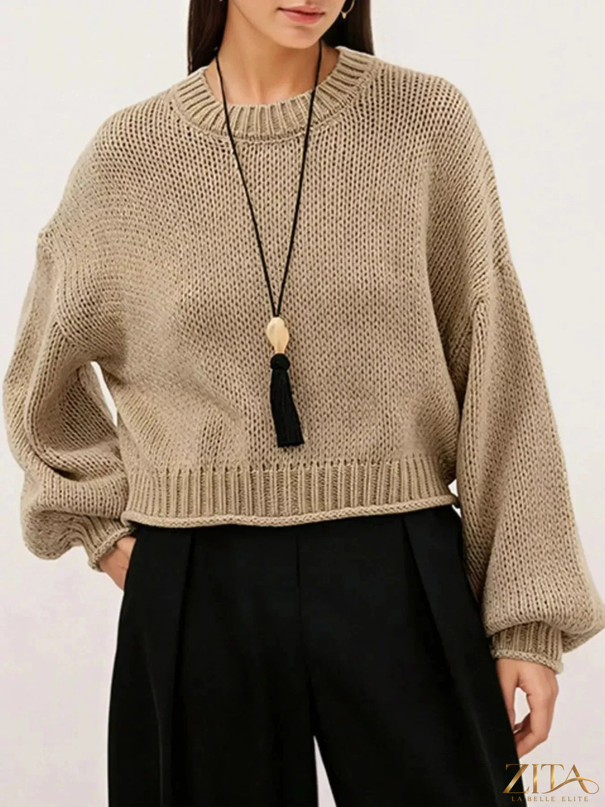 Oversized chunky knit sweater by Trendsi featuring thick yarn, relaxed fit, and cozy design in soft neutral tones.